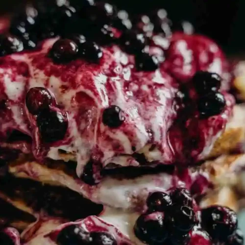 Freshly baked blueberry pancake casserole served with berry compote