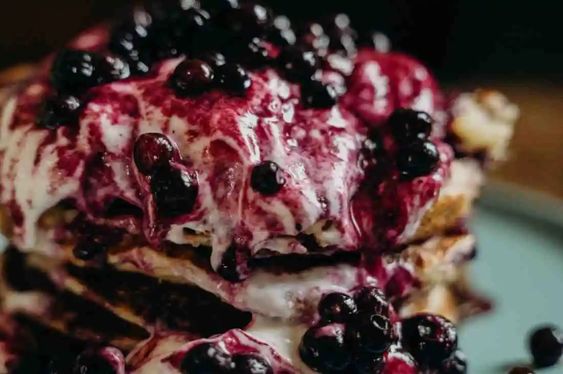 Freshly baked blueberry pancake casserole served with berry compote