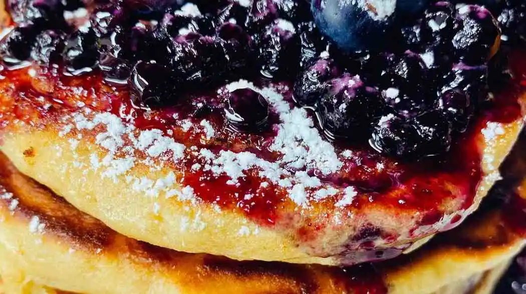 Easy blueberry buttermilk pancake casserole topped with fresh berries