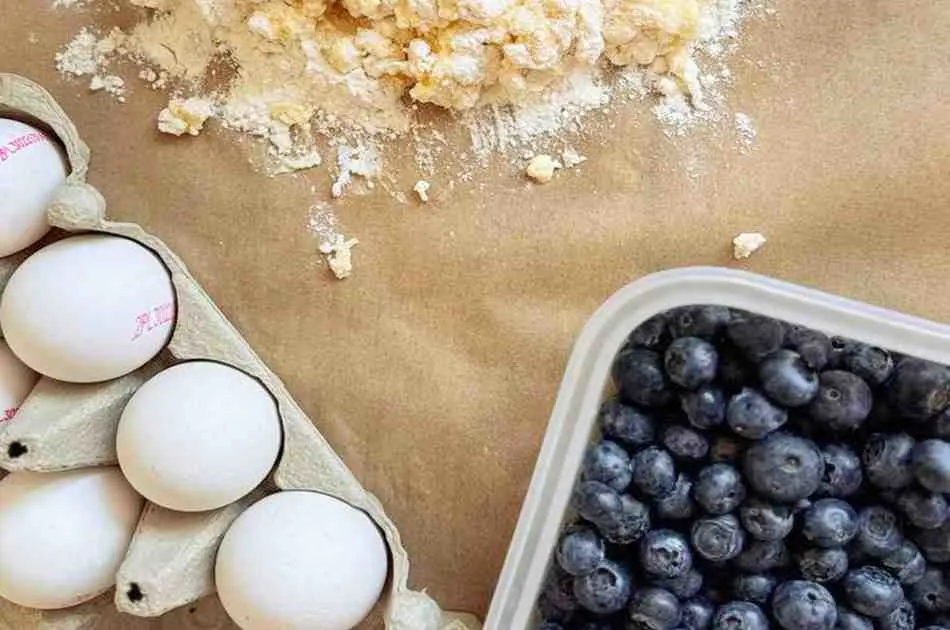 Ingredients for blueberry buttermilk pancake casserole including flour eggs and fresh blueberries