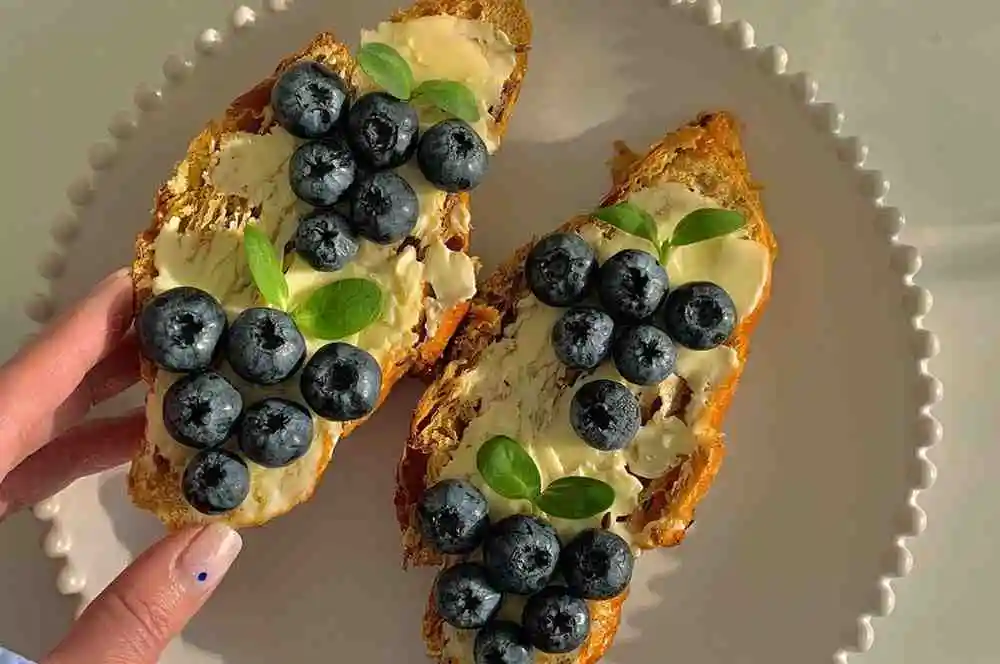 Layered bread with cream cheese and fresh blueberries for breakfast casserole
