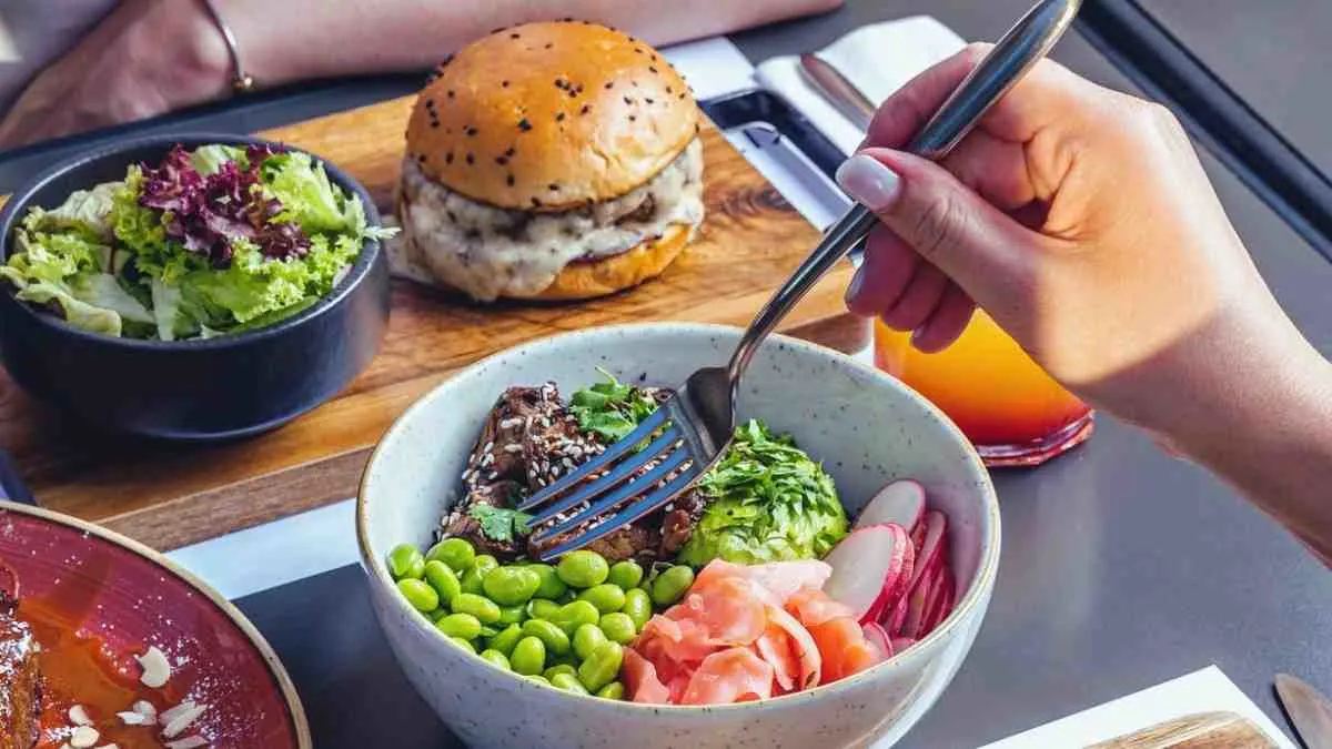 Chicken burger bowl meal prep served with fresh vegetables and rice