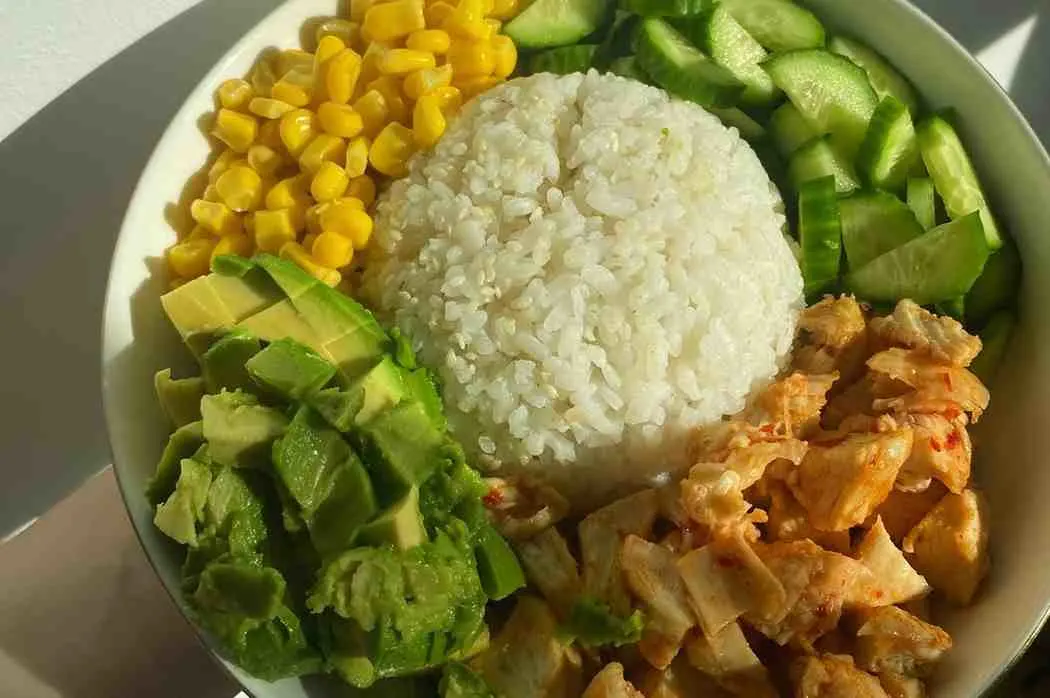 Chicken burrito bowl with rice corn avocado and black beans