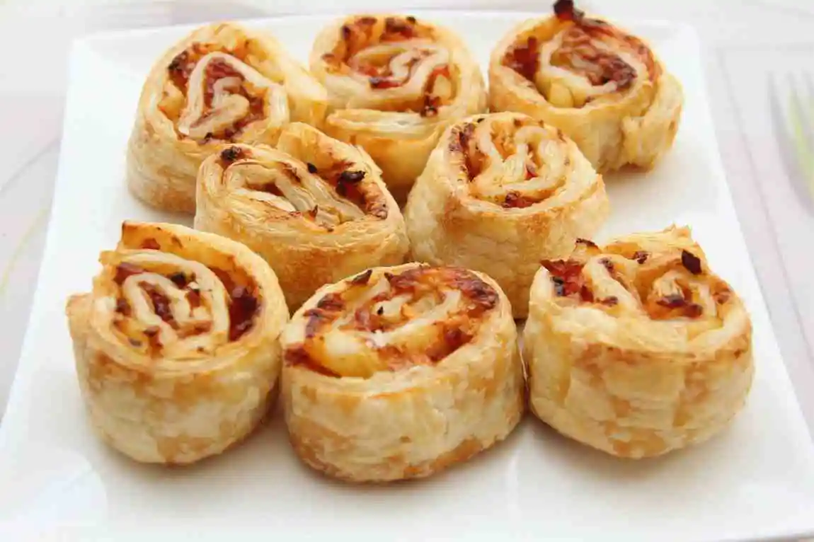 Baked bacon egg and cheese Hawaiian roll sliders on a serving plate