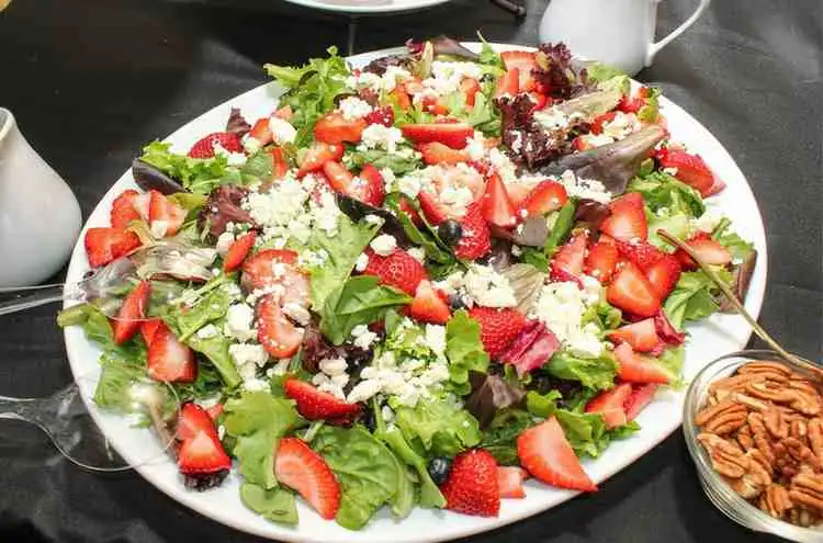 Plated cucumber strawberry salad with crumbled feta cheese