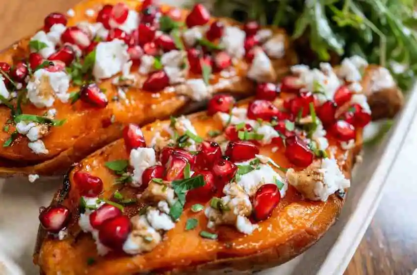 Freshly prepared Mediterranean sweet potato boats with feta cheese and fresh herbs