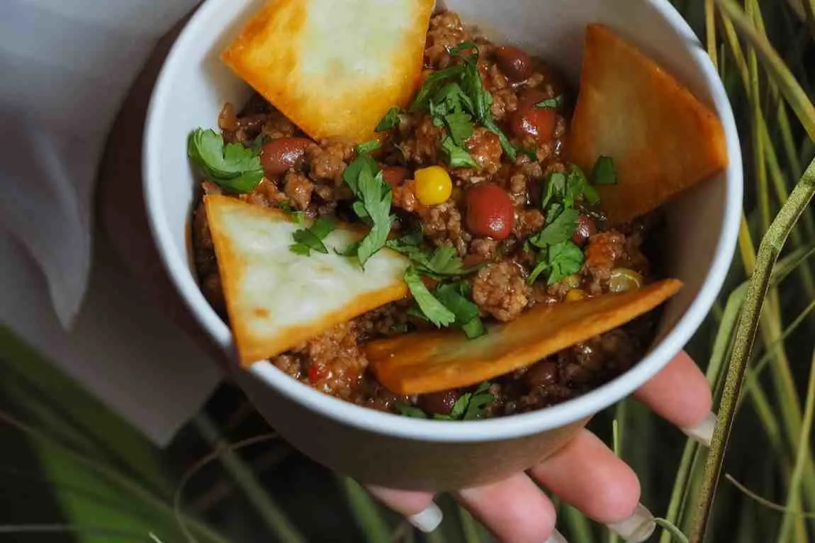 Southwest breakfast bowl garnished with fresh cilantro and tortilla chips