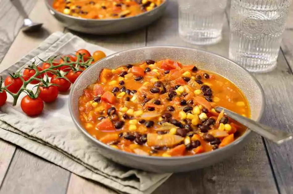 Southwest black bean and corn breakfast bowl served with tomatoes