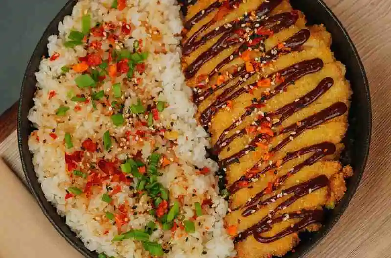 Japanese chicken katsu drizzled with tonkatsu sauce over rice