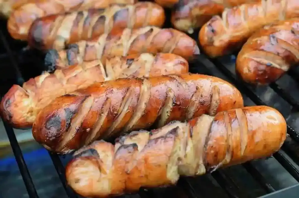 Golden browned scored chicken sausage ready to serve