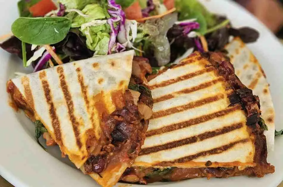 Mediterranean quesadillas with spinach, feta, mozzarella, and red onion
