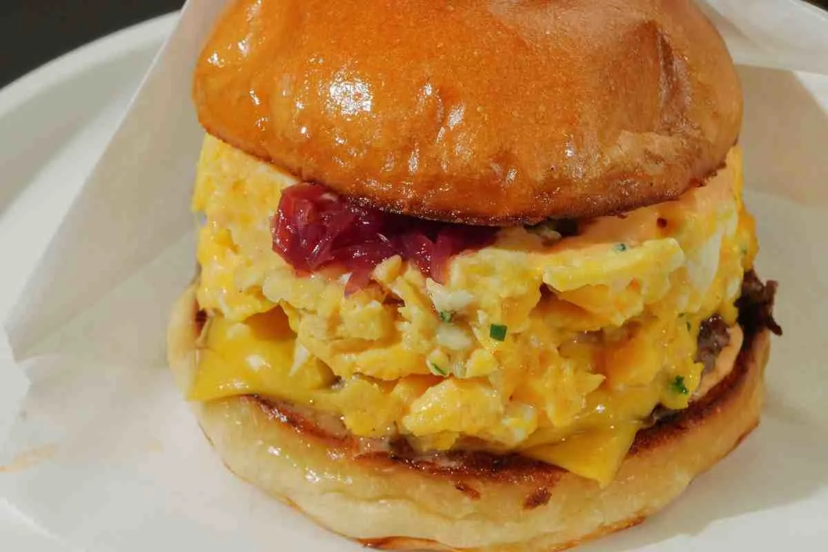 Homemade spicy chipotle egg breakfast sandwich with soft scrambled eggs and melted cheese