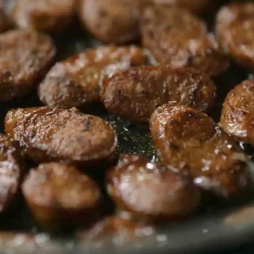 Slicing and browning Italian sausage in skillet