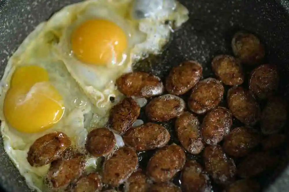 Italian sausage skillet served with fried eggs