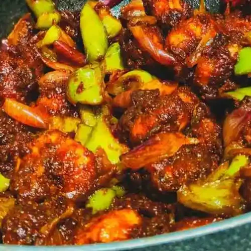 Easy keto steak and shrimp stir fry recipe cooking in a wok pan with juicy beef, shrimp, and vegetables.