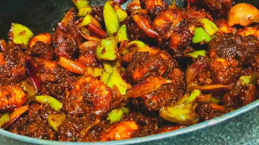 Easy keto steak and shrimp stir fry recipe cooking in a wok pan with juicy beef, shrimp, and vegetables.