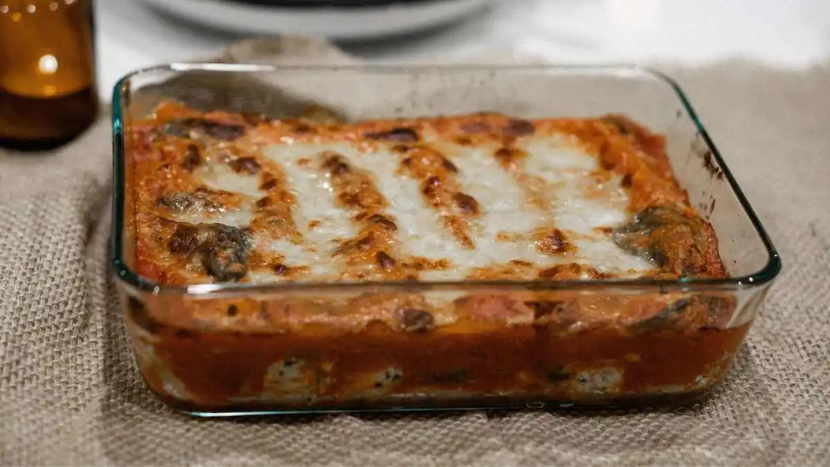 Freshly baked keto pizza casserole in a glass baking dish with savory tomato sauce and melted cheese